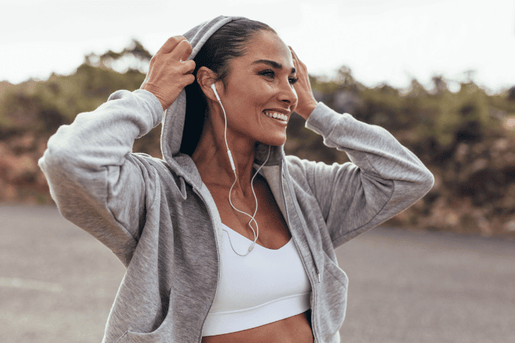 A smiling young woman in sports wear on a morning walk A smiling young woman in sports wear on a morning walk